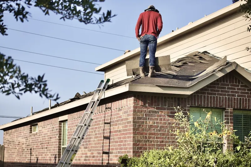 Professional roofer working on a residential roof in Indian Cave Park